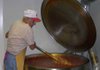 Roy Franco stirs a giant pot filled with 100 gallons of spaghetti sauce Wednesday at the St. Joseph Parish Hall in Tontitown. The sauce will be used for the 111th Tontitown Grape Festival's spaghetti suppers. A crew of volunteers will work to make 500 gallons of the sauce to ensure a steady supply. 
