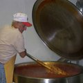 Roy Franco stirs a giant pot filled with 100 gallons of spaghetti sauce Wednesday at the St. Joseph ...
