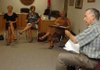 John Selph, Boston Mountain Education Cooperative director, right, who served as West Fork's district superintendent from 1988 to 2005, returned to the school to give his annual presentation on the history of the rural school district to new teachers Wednesday at the administration building. 