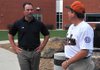 Former Bentonville Tigers baseball player and current Southern Arkansas head coach Allen Gum, left, spoke with Eagle Pass, Texas, head coach Javier Libson before the start of Thursday night's banquet at Bentonville High School welcoming players, coaches and families to the 13-year-old Babe Ruth Southwest Regional Tournament. Gum was the keynote speaker. The tournament begins today at Phillips Park in Bentonville.

