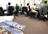 Job seekers search on computers at a Worksource office in Portland, Ore. Employers cut 247,000 jobs in July, the fewest in a year, and the unemployment rate dipped to 9.4 percent. 