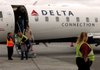 Passengers exit a Delta Air Lines flight from Atlanta at the Chattanooga, Tenn., airport earlier this year. The company says more budget cuts will help keep it strong and viable.