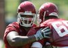 Arkansas offensive lineman Anthony Oden, left, runs a drill as teammate David Hurd holds the pad during practice Friday. Oden is making a push early for some playing time.