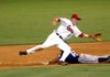 Arkansas second baseman Ryan Mount reaches for a throw from catcher Hank Conger as Northwest Arkansas' Jarrod Dyson slides into second base during Friday's game at Dickey-Stephens Park in North Little Rock.