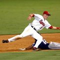 Arkansas second baseman Ryan Mount reaches for a throw from catcher Hank Conger as Northwest Arkansa...