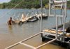 After helping launch a floating gangway from a truck, North American Marine employee Daniel Lawrence walked the gangway to a new encapsulated boat dock under construction near the Arkansas Highway 12 Bridge on Friday.  According to federal lay, all extruded polystyrene boat docks on U.S. Army Corps of Engineers Lakes in the nation must be of the encapsulated variety by 2013 to prevent further pollution.