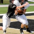 Senior defensive back Christian Larimer, left, tried to strip a pass from senior receiver Sheldon Va...