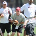 Arkansas coach Bobby Petrino takes a few snaps at quarterback while spelling freshman Brandon Mitche...