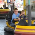 Kolton Dickens, 10, and his brother, Evan Dickens, 6, of Van Buren laugh while riding the bumper car...