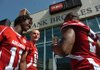 Arkansas sophomore quarterback Ryan Mallett (15) jokes with freshman wide receiver Cobi Hamilton (11) as he is being interviewed by senior wide receiver London Crawford (2) at Arkansas Media Day Saturday at Razorback Stadium in Fayetteville.