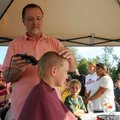 <b>Buzz cut</b>
Retired barber Mike Shivley gave Chandler Hansen, 5, a close and free haircut in pr...