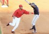 Arkansas Travelers left fielder Coby Smith tags out Northwest Arkansas center fielder Jarrod Dyson in a rundown between first and second in a 7-3 Naturals victory in North Little Rock on Sunday.