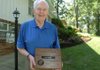 Former referee Bob Renner received a plaque after being inducted into the Arkansas High School Coaches Association-Arkansas Officials Hall of Fame in July after working
for more than 30 years as an official.