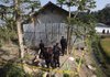 Indonesian police officers stand guard Sunday at a militants' hide-out a day after it was raided in Temanggung, central Java, Indonesia.