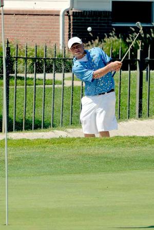 Rogers junior Jake Rylee blasted out of a sand trap at the par-3 8th hole during Monday's golf match against Fayetteville.