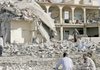 People gather Monday after a double bombing tore through a village of a small Shiite ethnic minority near Mosul, Iraq. Many of the dead and wounded were sleeping on their roofs because of the summer heat.