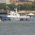 Divers in inflatable boats search Monday for the wreckage of a small plane that collided with a heli...
