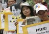 Protesters display placards and portraits of Burma opposition leader and Nobel Peace Prize laureate Aung San Suu Kyi during a protest at the Burman Embassy at Manila's financial district on Tuesday Aug. 11, 2009, in the Philippines. 