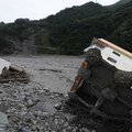 A collapsed apartment building sits in a river Monday in Taimali, Taiwan. At least 400 were unaccoun...