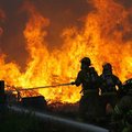 Firefighters work to control a blaze Monday afternoon at Paletta Pallet on Cloverdale Road near Avoc...
