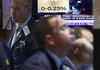 A television screen in a booth on the floor of the New York Stock Exchange on Wednesday shows the Fed interest rate decision.
