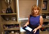  Rebecca Gwatney, wife of Bill Gwatney who was shot and killed in his office at the Democratic Party Headquarters in Little Rock on Aug. 13, 2008. She is in a den in their home where they spent time together. Rebecca is holding a framed napkin that Bill wrote on during a flight to Pebble Beach Golf Course in California. On it he listed the places he wanted to take her.