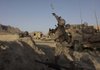 Marine Lt. Joe Cull hurls a smoke grenade to help provide cover for Afghan soldiers who were trying to lead women and children out of the way of possible crossfire Wednesday during an assault on Taliban forces in Dahaneh in Helmand province. The women and children got out safely.