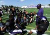 Fayetteville assistant coach Lerinezo Robinson speaks to members of his secondary during the Bulldogs' scrimmage Aug. 8 at Harmon Field.