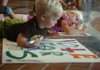 Grace Gheen, 5, right, and her brother Jack Gheen, 2, color posters supporting the Campaign for A Stronger Fayetteville on Wednesday at the East Square Plaza in Fayetteville. The campaign is striving to boost support for an increase in the city's property tax rate to fund the construction of a new high school. 
