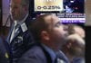 A television screen in a booth on the floor of the New York Stock Exchange on Wednesday shows the Fed interest rate decision. 