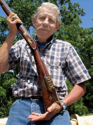 Michael "Hawkeye" Pierce of Eureka Springs displays the antique rifle black-powder rifle that launched his gun-collecting career as a youngster. The rifle was given to him by famed gun collector Col. C.B. Saunders of Berryville.

