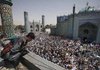 An Afghan police officer looks down Thursday from a rooftop as former Foreign Minister Abdullah Abdullah, a presidential candidate, gives a campaign speech at the Shrine of Hazrat Ali in the city of Mazar-i-Sharif. Afghanistan will hold presidential elections next Thursday.