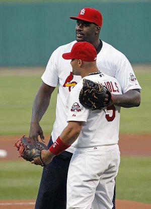 Cleveland Cavaliers center Shaquille O'Neal was in St. Louis to take on Cardinals first baseman Albert Pujols
(front) in a home run derby Thursday for O'Neal's reality show on ABC.
