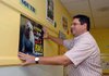 Leverett Elementary School fourthgrade teacher Rick Sullins puts up a poster in his classroom Thursday
morning as he and other teachers prepare for the start of school next week in Fayetteville.