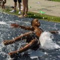 <b>Sliding out of summer</b>
Xavier Mason, 6, slides down a homemade water slide during the Donald ...