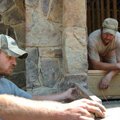 <b>Making it level</b>
Mike Cowan, left, uses a level while he and Gary Smith lay stone on the fron...