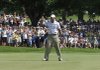Tiger Woods holds up his ball after a birdie putt on the seventh green during the second round of the 91st PGA Championship at the Hazeltine National Golf Club in Chaska, Minn., on Friday.