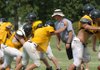 Prairie Grove head coach Danny Abshier works with his linemen during practice Aug. 6 in Prairie Grove.
