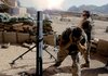 U.S. Marines fire mortars on Taliban positions in the mountains after Taliban shells struck just outside the walls of their forward operating base in Now Zad on Sunday in the Helmand province of Afghanistan.