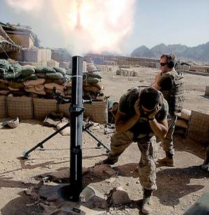 U.S. Marines fire mortars on Taliban positions in the mountains after Taliban shells struck just outside the walls of their forward operating base in Now Zad on Sunday in the Helmand province of Afghanistan.