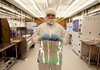 Michael Kocisis, a senior engineer at Kovio Inc., holds a steel sheet imprinted with silicon ink.