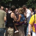 Participants in the Great Nationwide Kiss-In smooch Saturday in front of the Fayetteville Town Cente...
