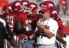 Arkansas head coach Bobby Petrino helps pumps up the team during practice Saturday at Razorback Stadium in Fayetteville.