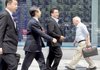 People walk by an electronic stock indicator in Tokyo on Monday, as Japan's government said the nation's economy pulled out of recession in the second quarter.
