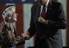 President Barack Obama is greeted prior to speaking at the Veterans of Foreign Wars National Convention in Phoenix, Monday.