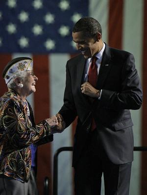 President Barack Obama is greeted prior to speaking at the Veterans of Foreign Wars National Convention in Phoenix, Monday.