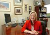 Suzanne Clark sits in her office at the Kutak Rock LLC law firm surrounded by photos of her husband, Fayetteville Chamber of Commerce President Steve Clark, and their family. 