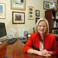 Suzanne Clark sits in her office at the Kutak Rock LLC law firm surrounded by photos of her husband,...