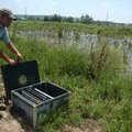 Graydan Carruth, operator one with CH2M Hill OMI, puts the cover back on a control box that regulate...