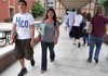 Bentonville freshman Tristan Vaughan, 14, of Bentonville walked from the South Building to the North Building with his sister, Kendra Williams, during the first day of school for freshmen at Bentonville High School on Monday.